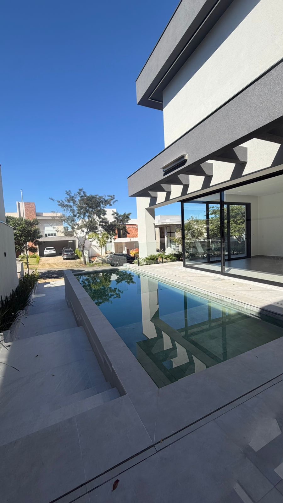Piscina com borda e deck em pedra clara